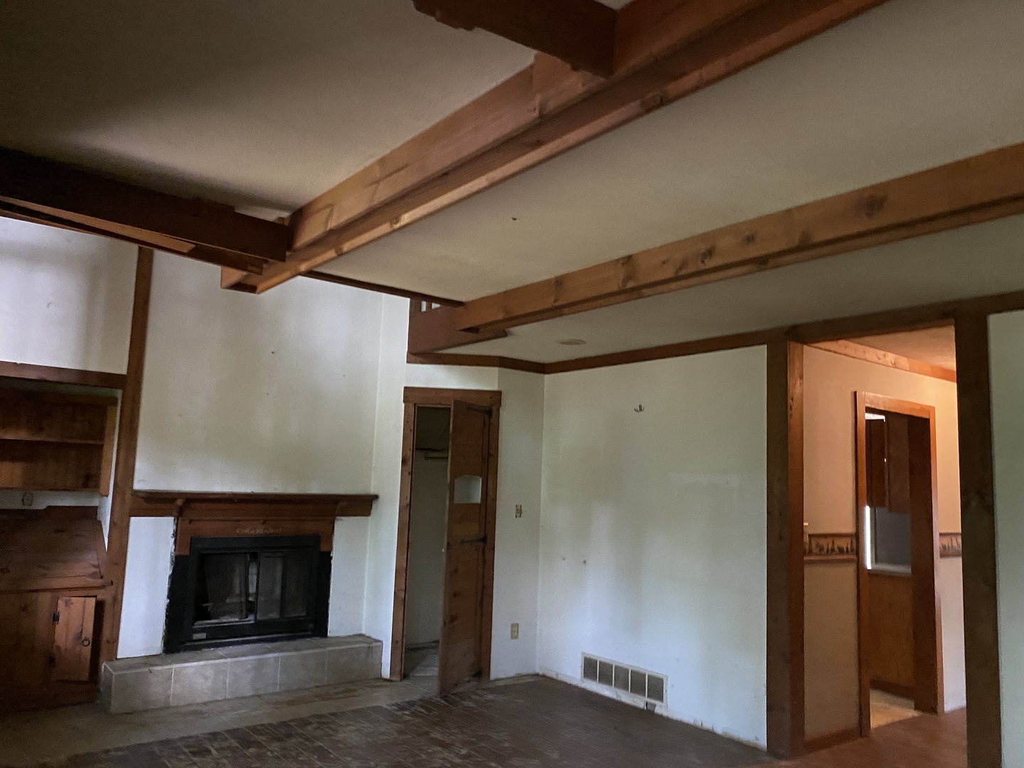 19209 Altenburg Road Harvard, IL 60033 - Photo 7 of 13 a view of an empty room with wooden floor fireplace and a window