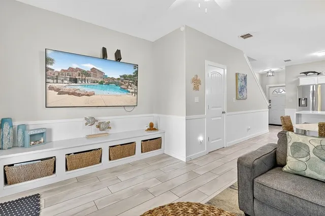 a living room with furniture and view of kitchen