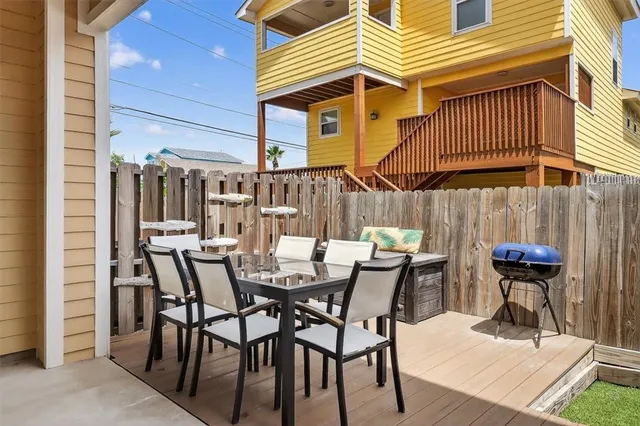 a view of a patio with a table and chairs and wooden floor