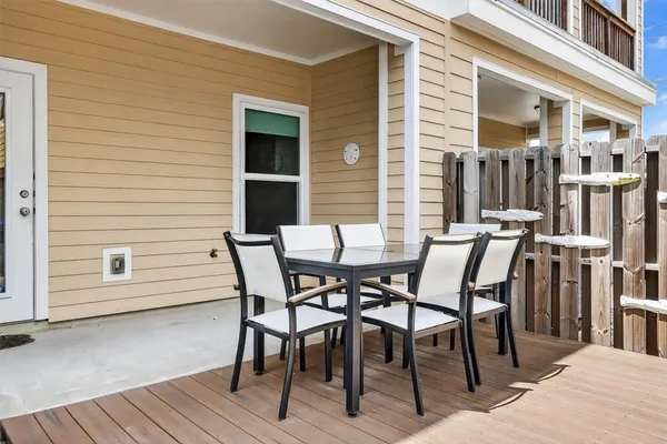 a view of a patio with table and chairs and wooden floor