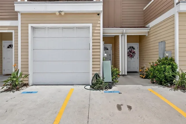 a view of a patio with table and chairs potted plants