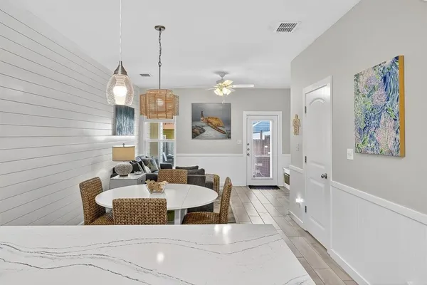 a bathroom with a granite countertop sink a mirror and shower