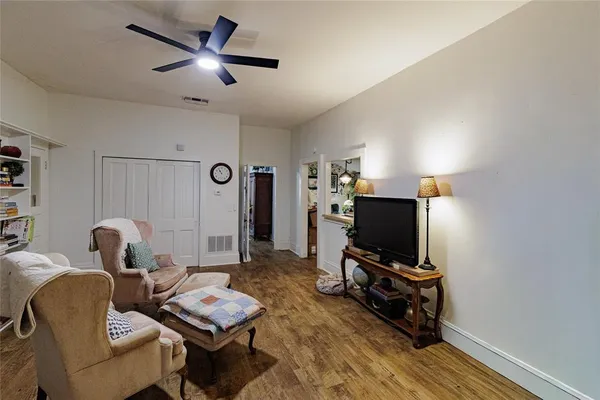 a living room with furniture and a book shelf
