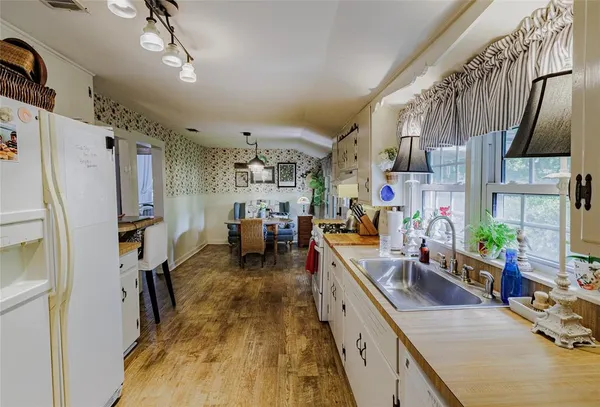 a living room with kitchen island furniture and a chandelier