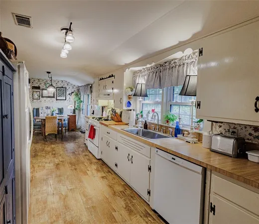 a bathroom with a sink mirror and shower