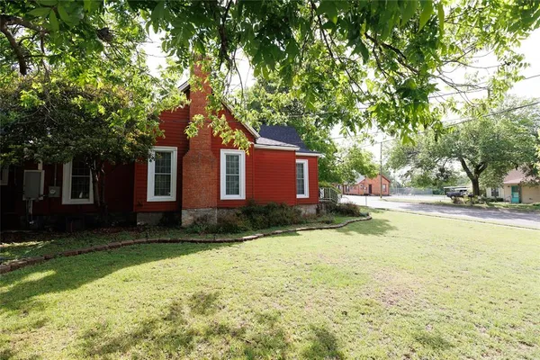 a front view of a house with yard and green space