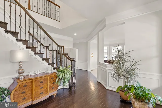 a kitchen with granite countertop white cabinets and stainless steel appliances