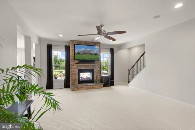 a bathroom with a granite countertop sink toilet and mirror