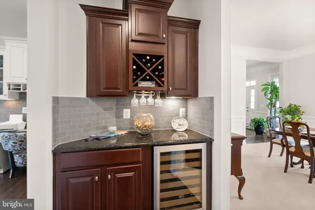 a view of a livingroom with a chandelier fan and a window