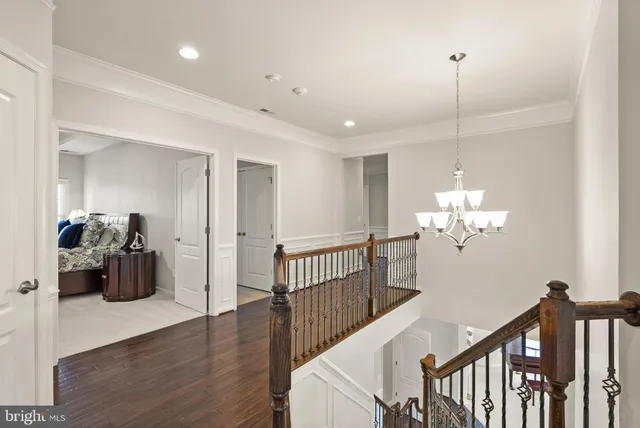 a view of a chair and table in the garden in front of house