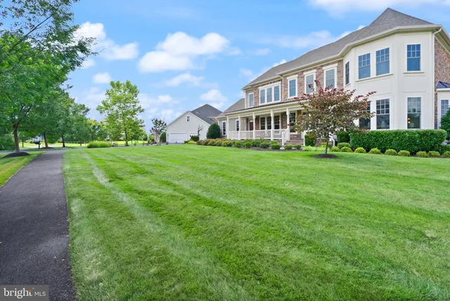 a view of a house with a yard and outdoor seating