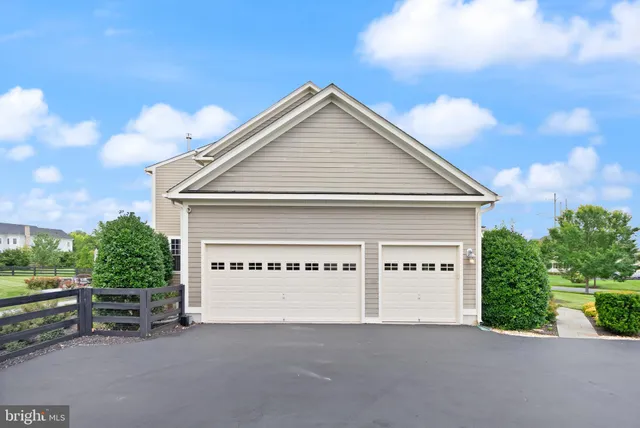 a living room with furniture and a large window with wooden floor