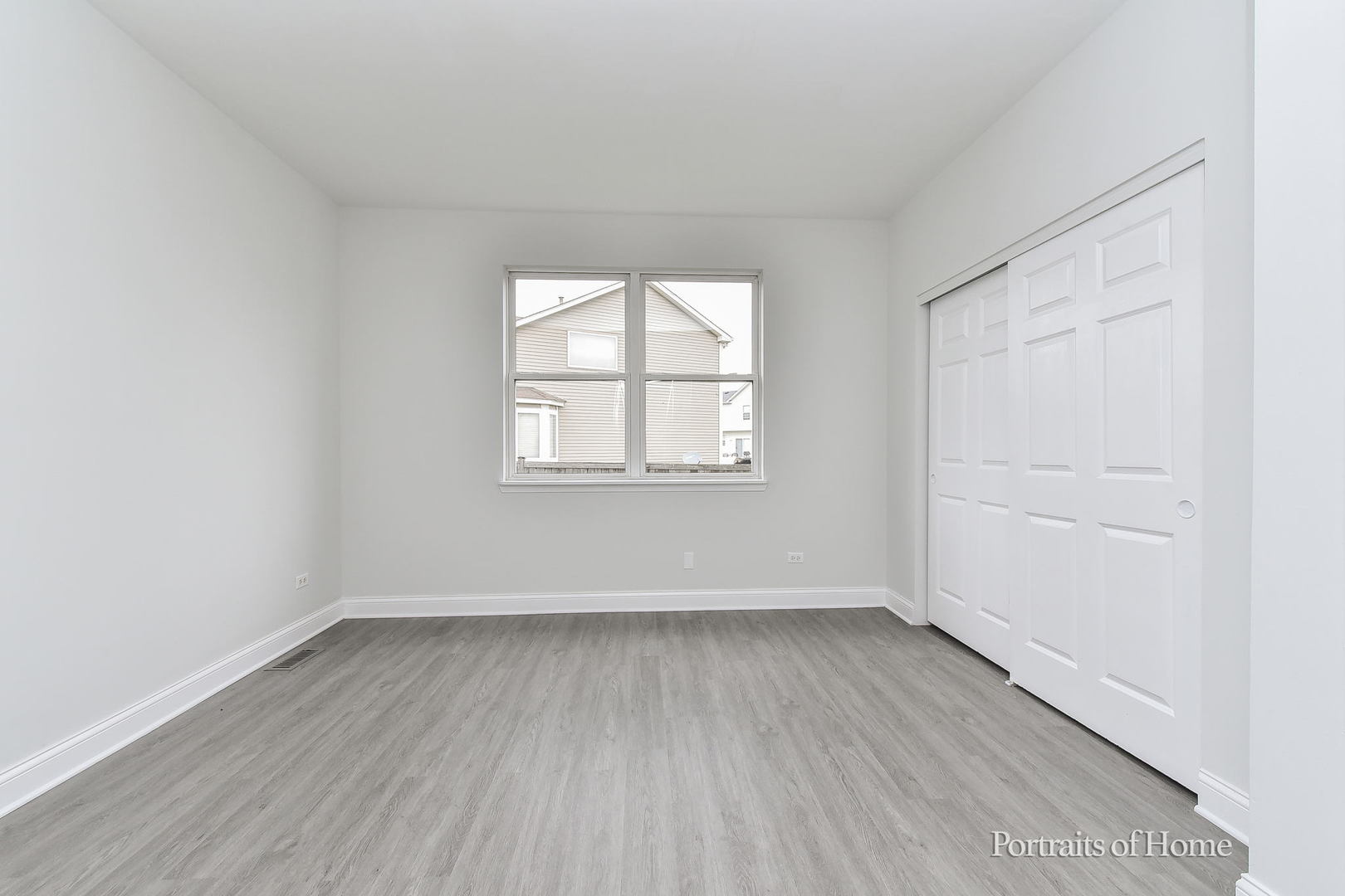 1412 Colaric Court Joliet, IL 60431 - Photo 5 of 25 an empty room with wooden floor and windows