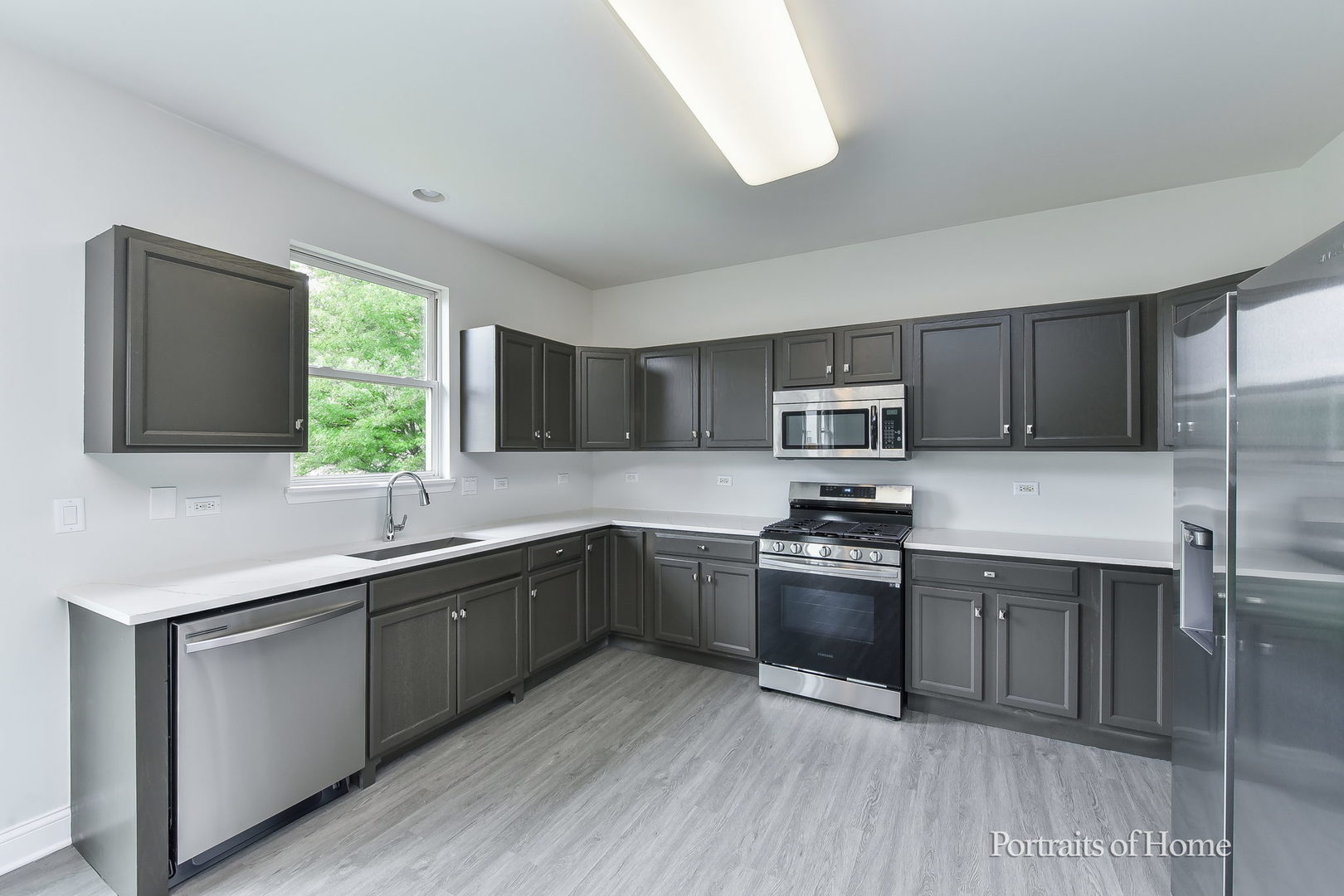 1412 Colaric Court Joliet, IL 60431 - Photo 6 of 25 a kitchen with stainless steel appliances granite countertop a sink stove and refrigerator