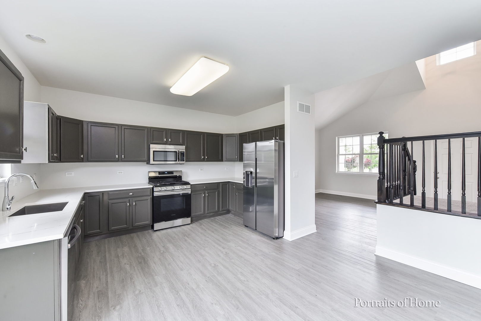 1412 Colaric Court Joliet, IL 60431 - Photo 8 of 25 a large kitchen with a wooden floor and stainless steel appliances