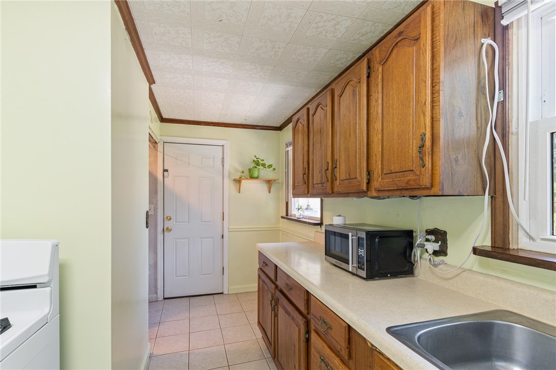 206 English Road Greece, NY 14616 - Photo 11 of 24 The kitchen to the garage entry view- also takes y