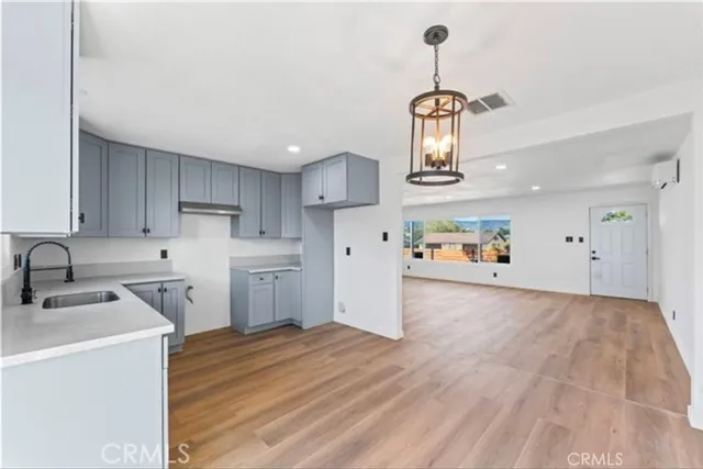 a kitchen with refrigerator a sink and cabinets