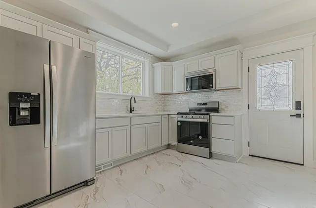 a kitchen with a refrigerator stove and microwave