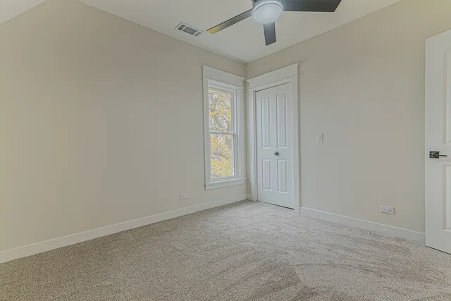 an empty room with windows and closet