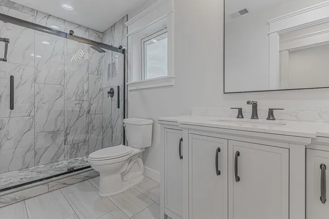 a bathroom with a sink toilet and shower