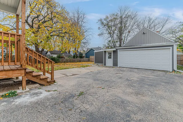 a view of a house with a yard and sitting area