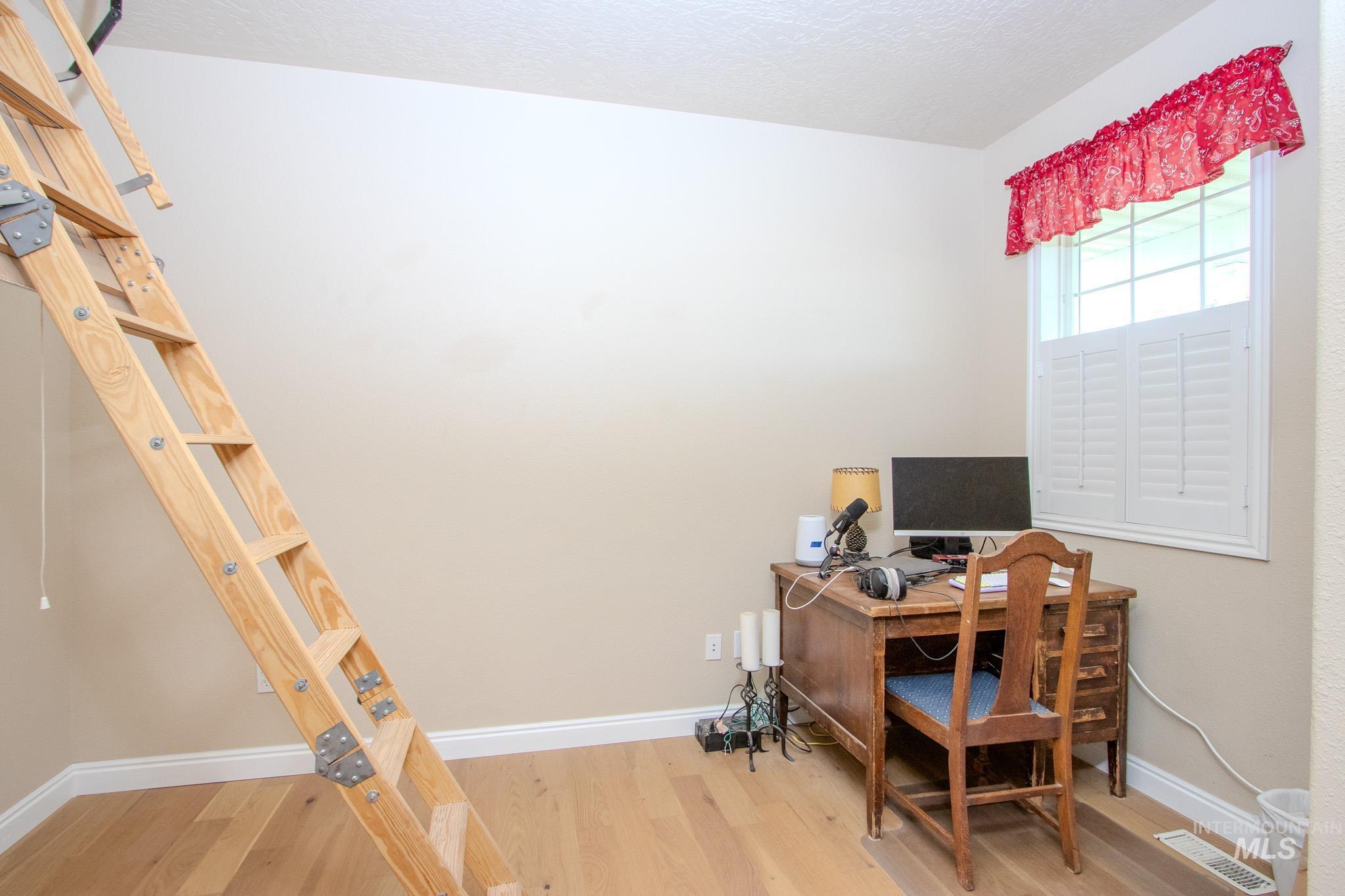 13569 Midway Road Nampa, ID 83651 - Photo 12 of 25 Office area with wood finished floors and a textured ceiling