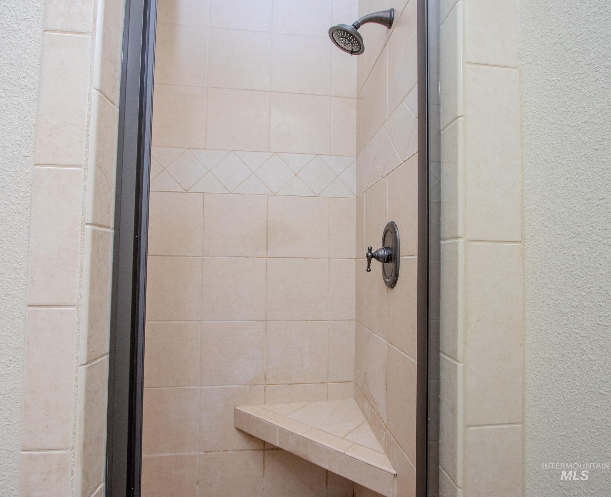 13569 Midway Road Nampa, ID 83651 - Photo 15 of 25 Full bath featuring a stall shower and a textured wall