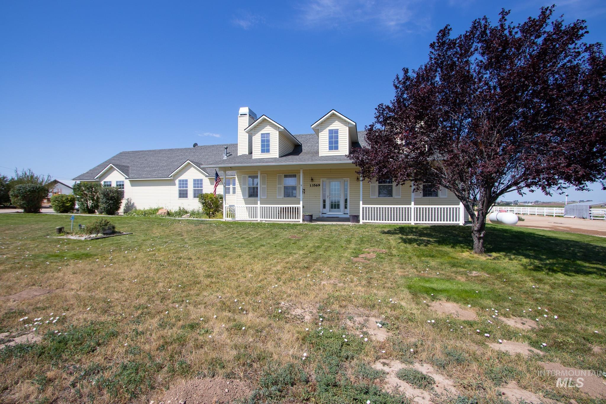13569 Midway Road Nampa, ID 83651 - Photo 2 of 25 View of front of property featuring a porch, a front yard, and a chimney