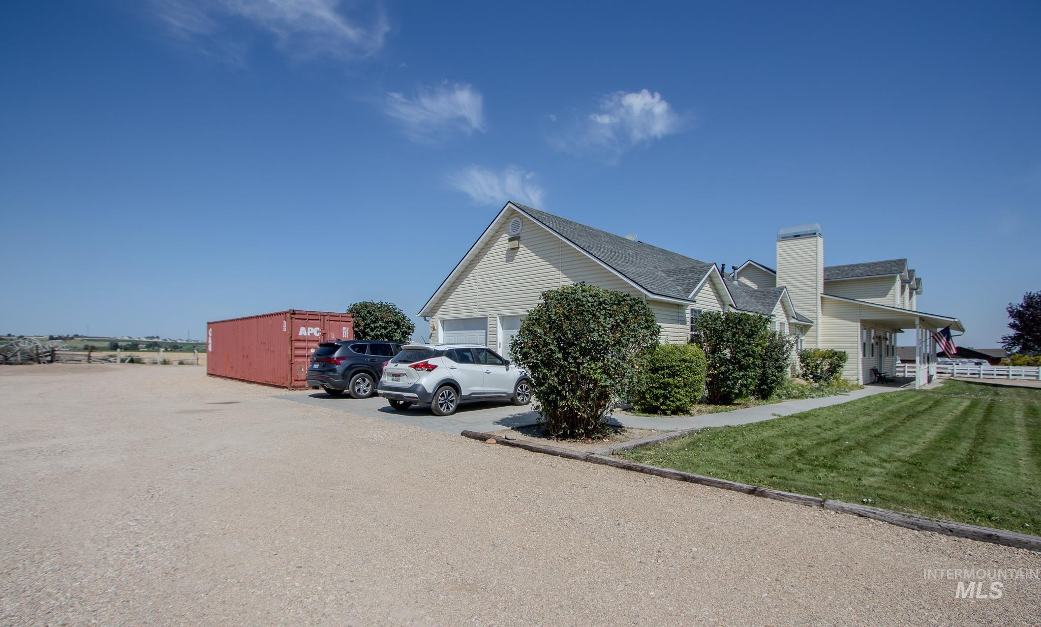 13569 Midway Road Nampa, ID 83651 - Photo 4 of 25 View of home's exterior with a yard, a chimney, and an outdoor structure