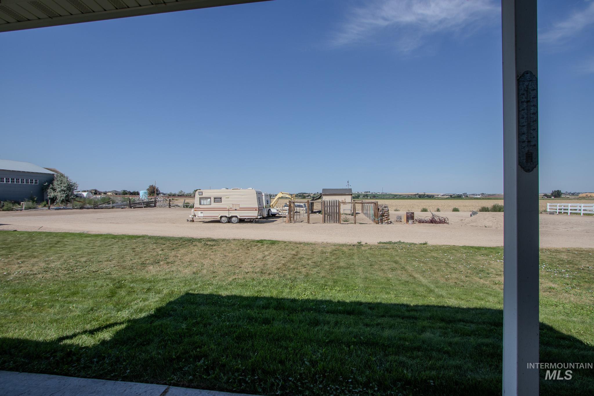 13569 Midway Road Nampa, ID 83651 - Photo 6 of 25 View of green lawn featuring a view of rural / pastoral area
