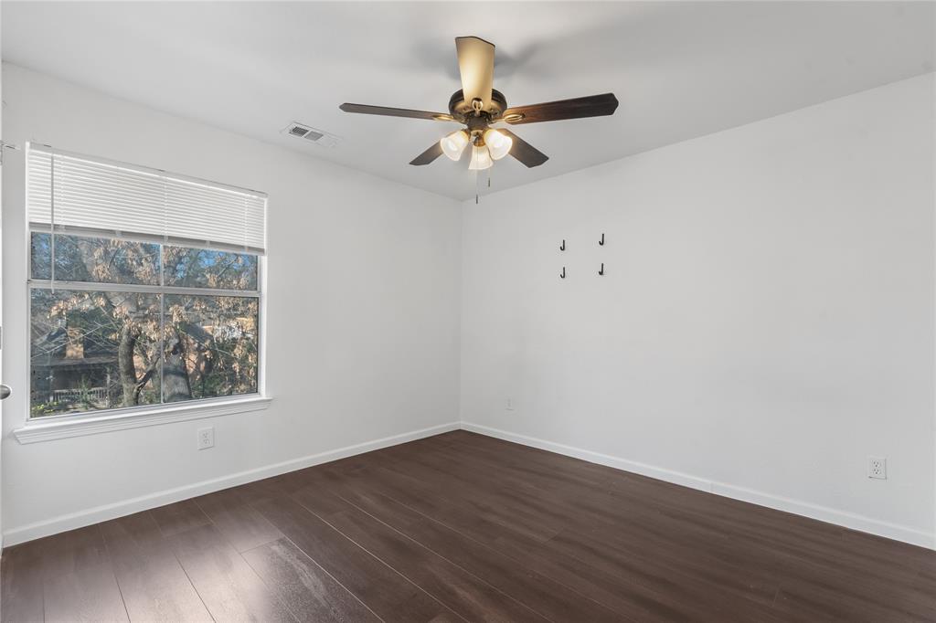 225 Freedom Court Rockwall, TX 75032 - Photo 21 of 28 a view of an empty room with wooden floor and a window