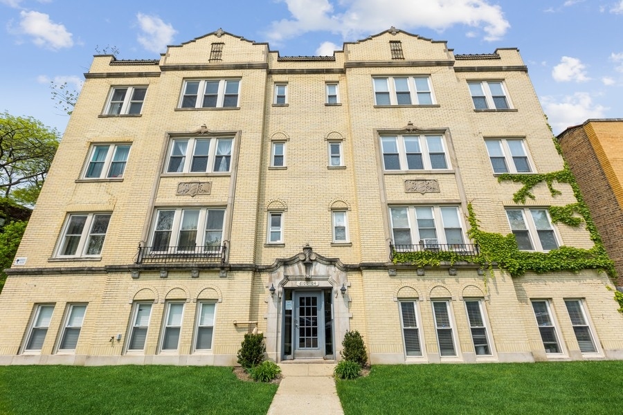 a front view of a building with a garden