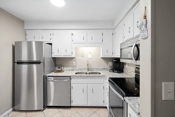 a kitchen with stainless steel appliances a refrigerator sink and cabinets