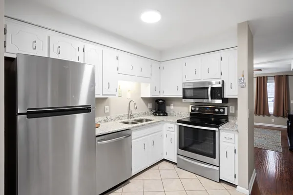 a white refrigerator freezer sitting in a kitchen