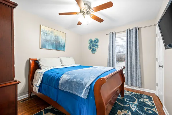 a bedroom with bed and a window