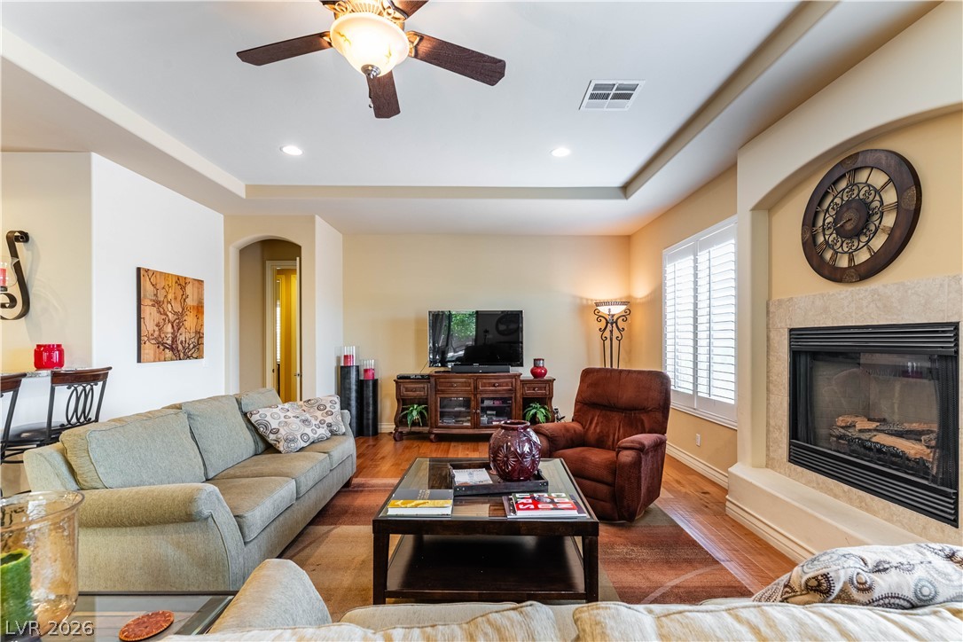 3661 Riley Ann Avenue Las Vegas, NV 89139 - Photo 9 of 42 An inviting living area with rich hardwood flooring and a cozy fireplace creates a comfortable ambiance.