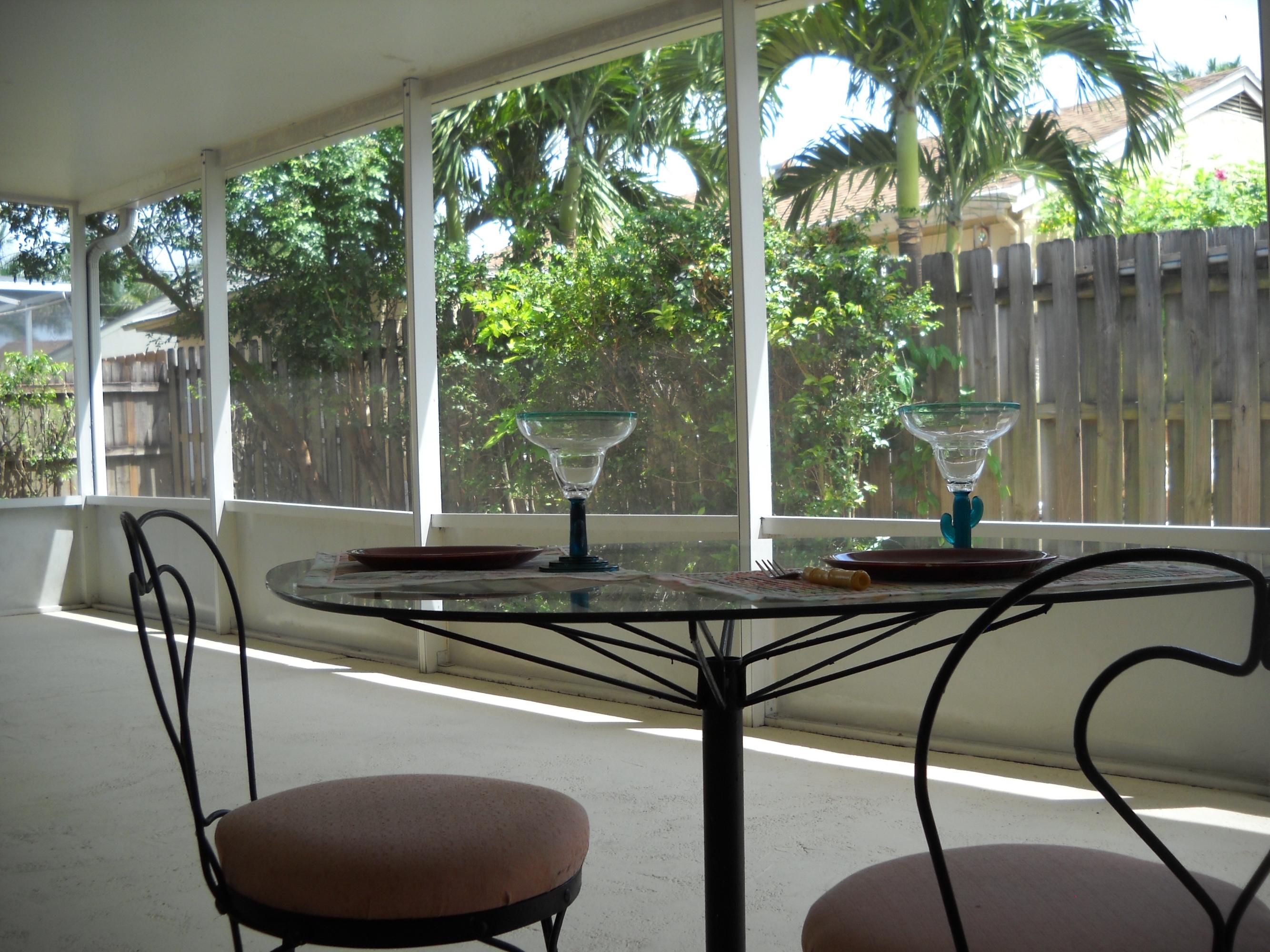 18746 Shauna Manor Drive Boca Raton, FL 33496 - Photo 16 of 20 porch sitting area w garden view