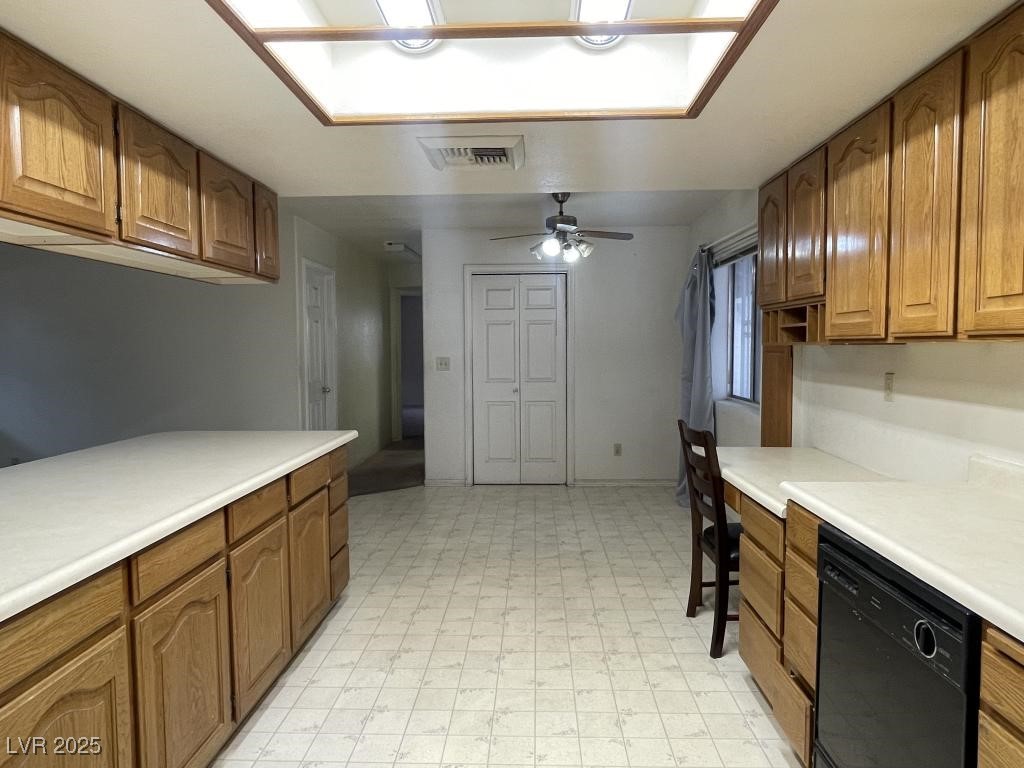 3530 North Pecos Road Las Vegas, NV 89115 - Photo 25 of 46 Kitchen featuring brown cabinets, light floors, light countertops, visible vents, and dishwasher