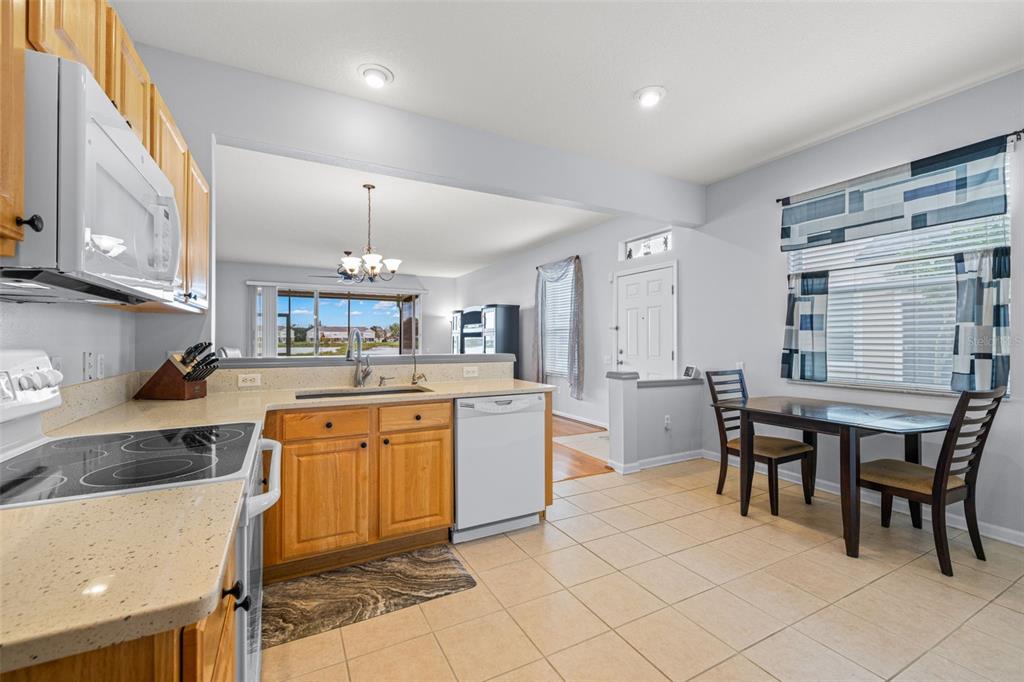 4921 Pond Ridge Drive Riverview, FL 33578 - Photo 12 of 40 a kitchen with cabinets and chairs in it