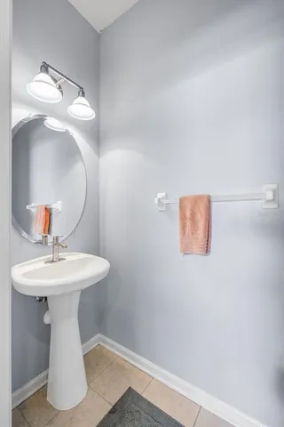 a bathroom with a sink toilet and mirror