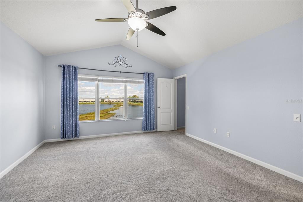 4921 Pond Ridge Drive Riverview, FL 33578 - Photo 16 of 40 an empty room with a large window and a ceiling fan