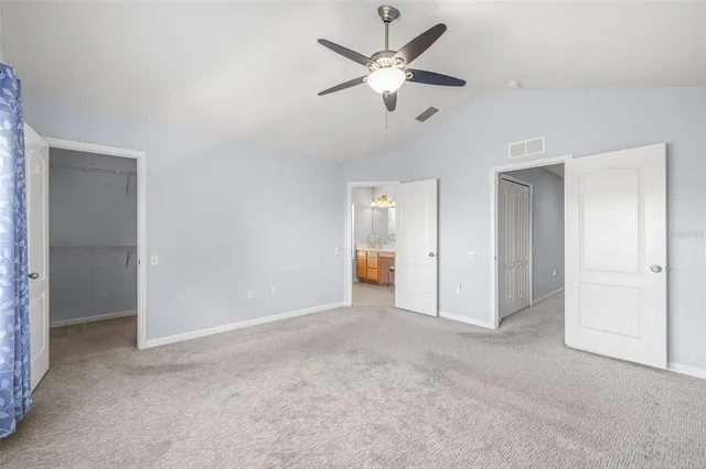 an empty room with fan and entrance