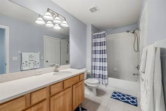 a bathroom with a double vanity sink mirror and toilet