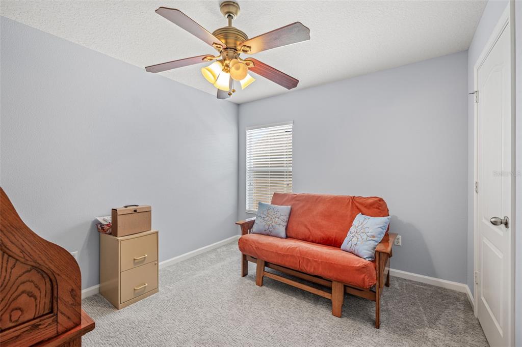 4921 Pond Ridge Drive Riverview, FL 33578 - Photo 24 of 40 a bedroom with a bed and a chandelier