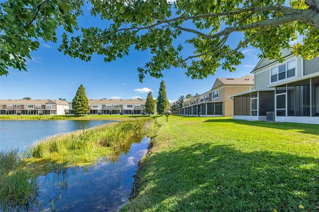 a view of a house with swimming pool and a yard