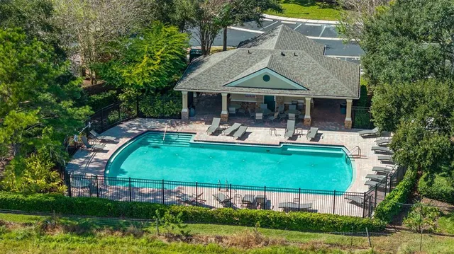 an aerial view of a house with swimming pool garden and patio