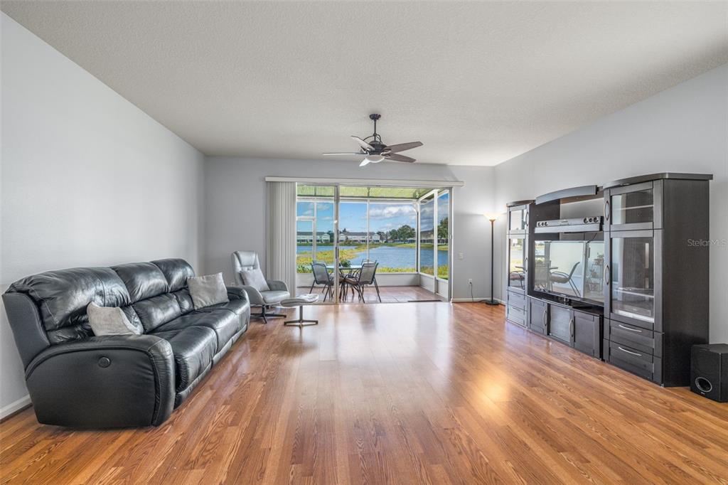 4921 Pond Ridge Drive Riverview, FL 33578 - Photo 7 of 40 a living room with furniture and a wooden floor