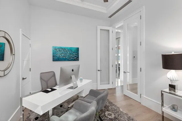 a kitchen with a white cabinets and chairs