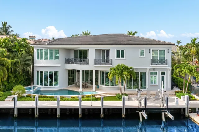 a view of a house with swimming pool and porch