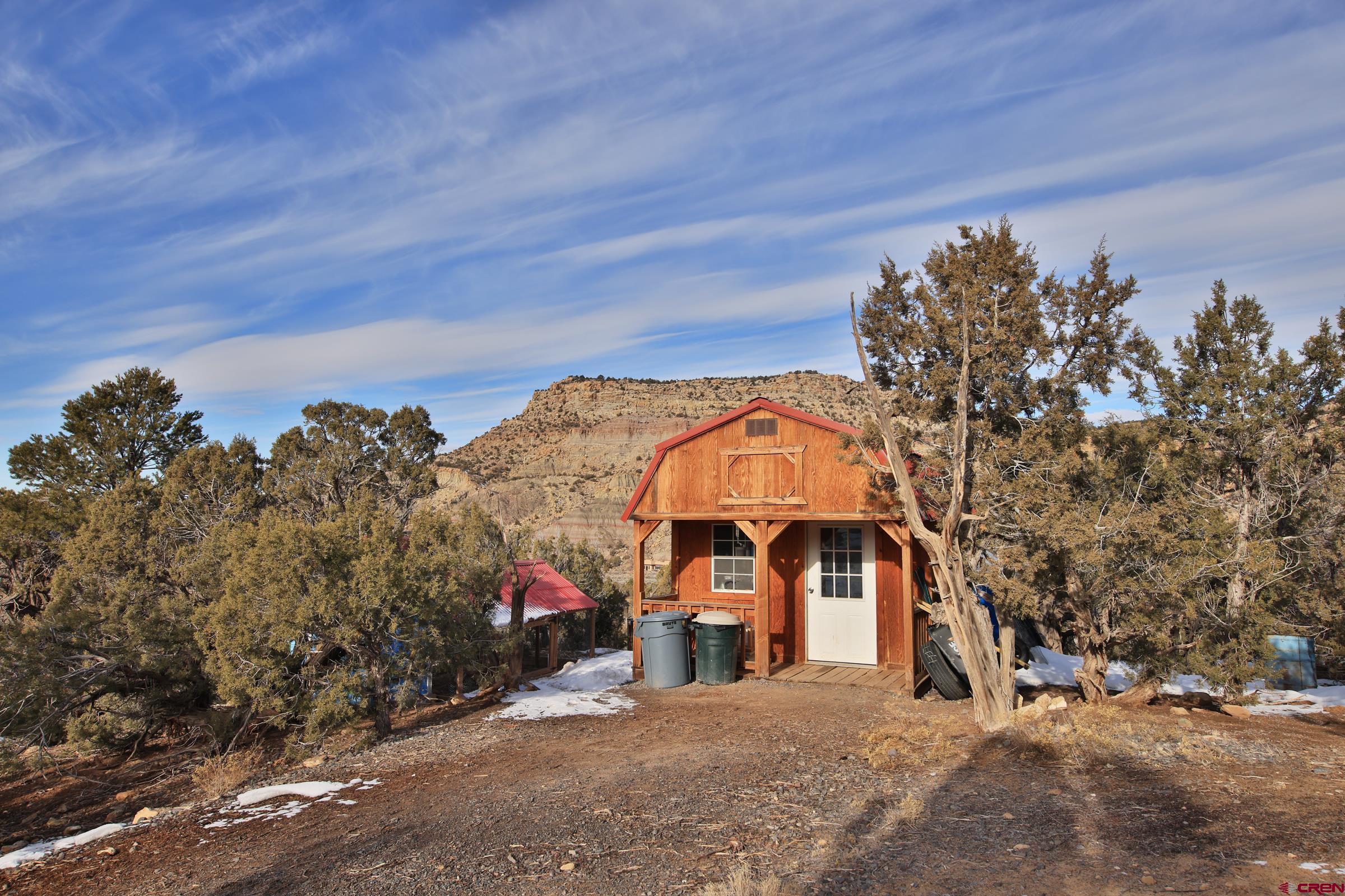 15086 45 45 1/2 Road De Beque, CO 81630 - Photo 12 of 40 a view of a big house with a mountain in the background